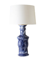 The Canyon Drip Banded Cobalt Lamp by Paul Schneider Ceramics features a white cylindrical shade, blue marbled ceramic cove base, and dimmer socket, shown against a white background.
