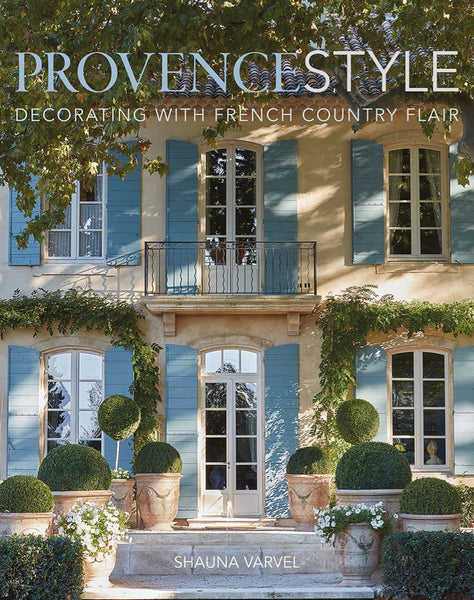 Cover of the 'Provence Style' book showcasing a French country house with topiary plants and traditional blue shutters by Common Ground.