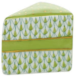The Herend "Slice of Cake" is a ceramic box designed to look like a cake slice, with hand-painted green and gold icing and geometric patterns—a delightful collectible for anyone who loves artistic decor.