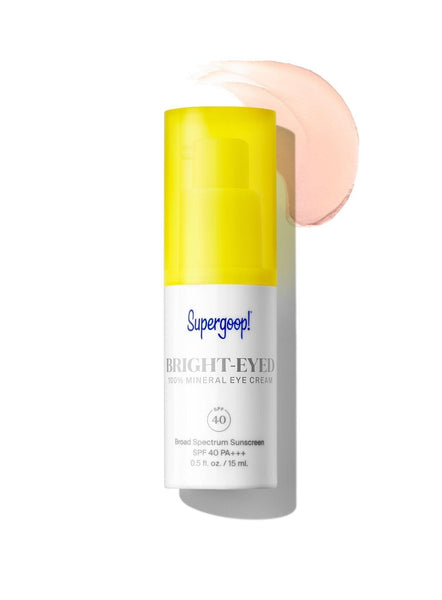A white bottle with a yellow lid, perfect for Supergoop! Bright-Eyed Mineral Eye Cream SPF 40 protection.