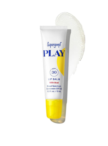 A tube of Supergoop! Play Lip Balm SPF 30 with Acai, enriched with shea butter, with a swipe of the product displayed beside it.