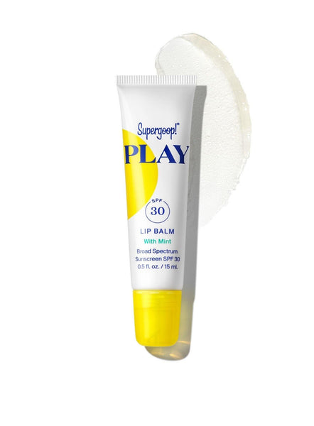 A tube of Supergoop! Play Lip Balm SPF 30 with Mint designed for sun-sensitive lips, with a swipe of the product applied next to it.