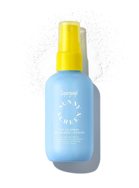 A bottle of Supergoop! Sunnyscreen 100% Mineral Spray SPF 50 sunscreen for babies and kids, gentle and hypoallergenic, displayed against a white background with a smeared white substance around it, possibly.