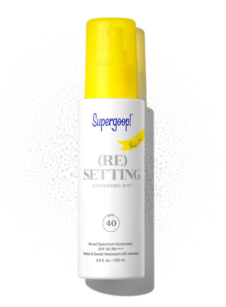 A bottle of Supergoop! (Re)setting Refreshing Mist SPF 40 sunscreen, isolated on a white background.