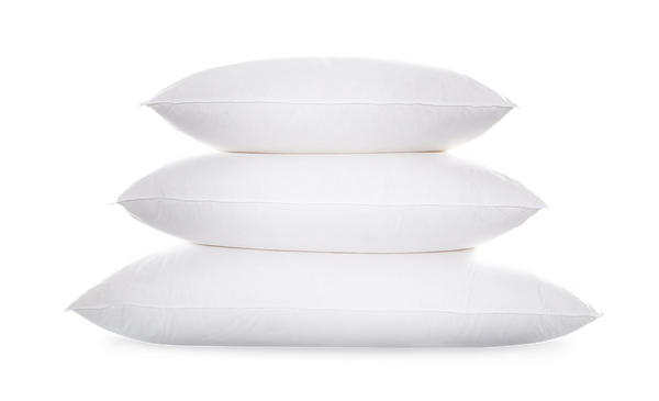 Three stacked white Matouk Valletto Goose Down Pillows against a light background.