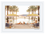People relax by a palm-lined pool with yellow umbrellas at sunset in Gray Malin’s Poolside The Breakers Palm Beach, White Frame, 29.5" x 41.5", by Gray Malin, capturing ocean views and the essence of luxury living.