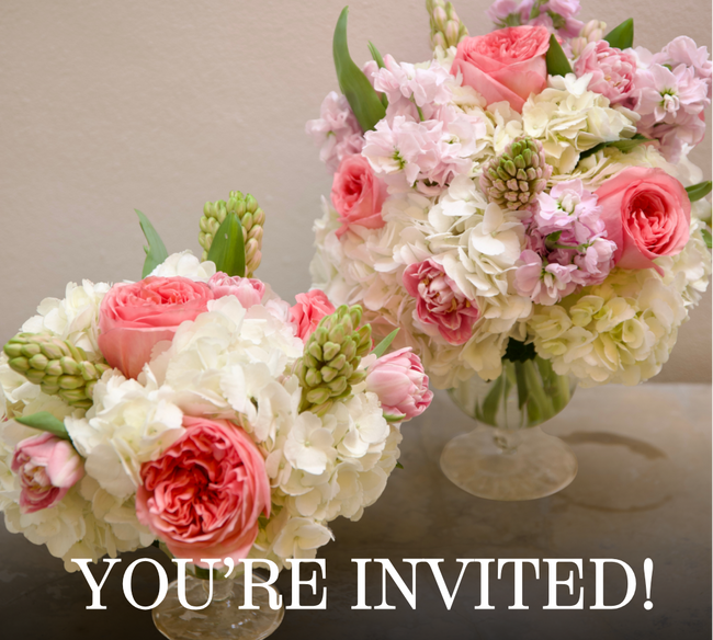 two pink and white floral arrangements in glass vases