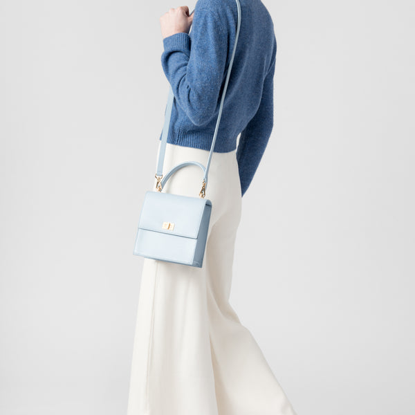 image of model with Neely & Chloe blue shoulder bag