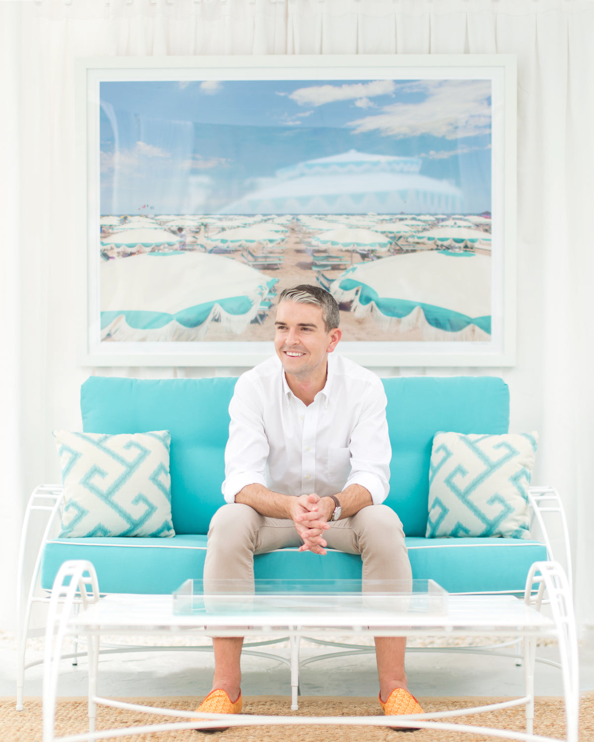 Image of Gray Main sitting on turquoise sofa