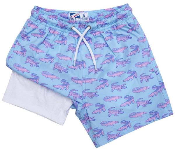 Blue and pink Bermies Boys' Compression Lined Swim Trunks with crocodile print for muscle support. Ideal for active kids.