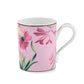 A pink ceramic mug from the Ginori 1735 Florenza Impero Malva Dinnerware and Decor Collection, featuring a curved handle and adorned with an elegant motif of pink and yellow flowers with green leaves, inspired by the refined beauty of Italian porcelain and classic Tuscany tableware.