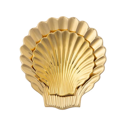 A trio of Arista Polished Gold Clam Shell trays by Pigeon & Poodle are nested together, each featuring an elegant seashell design in a shimmering gold finish, displayed against a plain white background. Ideal as an ocean-inspired jewelry catch-all, these trays bring a touch of coastal charm to any setting.