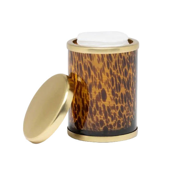 A cylindrical container from Pigeon & Poodle’s Benton Tortoise Bath Collection, featuring a gold and tortoiseshell pattern, holds white tissues with its gold lid beside it—a stylish accent for any bath.