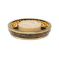A round bar of soap rests in a decorative soap dish featuring a tortoise pattern and gold trim from the Benton Tortoise Bath Collection by Pigeon & Poodle, bringing elegant style to your bathroom.