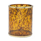 The Benton Tortoise Bath Collection by Pigeon & Poodle features a cylindrical amber glass container with a dark brown mottled pattern and gold-toned rims, adding sophisticated charm to your bath décor.