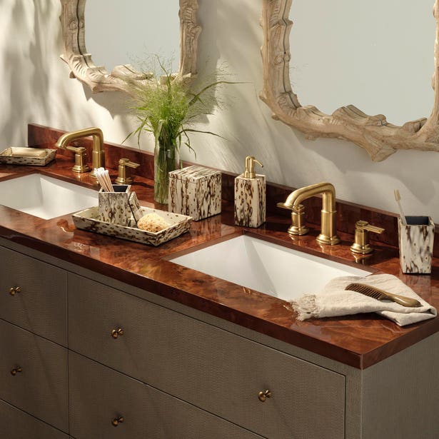 Pigeon & Poodle Bisbee Bath Collection vanity set featuring a patterned tray, soap dispenser, canister, and cup with a matching birdseye burl veneer spotted print.