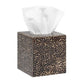 A cube-shaped tissue box from the Pigeon & Poodle Callas Bath Collection displays a brown and black animal print and dispenses a white facial tissue from the top.