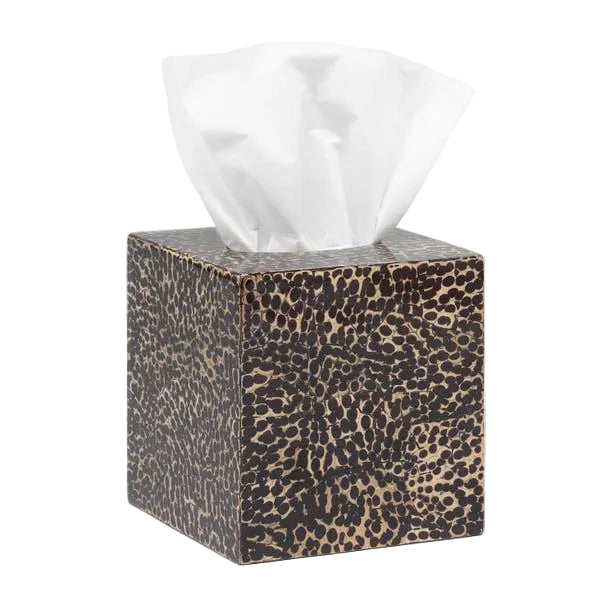 A cube-shaped tissue box from the Pigeon & Poodle Callas Bath Collection displays a brown and black animal print and dispenses a white facial tissue from the top.