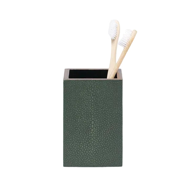 The Manchester Bath Collection by Pigeon & Poodle features a green shagreen-textured toothbrush holder with two bamboo toothbrushes with white bristles, shown on a plain light background.
