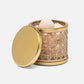 A round container from the Norwell Bath Collection by Pigeon & Poodle, crafted with woven rattan and a gold-colored rim and lid, sits partially open to reveal several eggs inside.