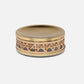 A round, gold-toned metal box with a woven rattan band from Pigeon & Poodle's Norwell Bath Collection, displayed against a plain white background.