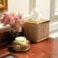 A tissue box, soap dish with bar soap, and vase with pink flowers from the Pigeon & Poodle Norwell Bath Collection sit on a polished marble countertop by a white wall with gold trim, highlighting their sophisticated silhouettes.
