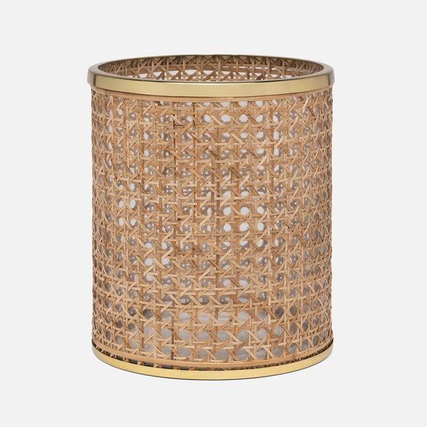 Part of the Norwell Bath Collection by Pigeon & Poodle, this wastebasket features elegant silhouettes with woven rattan and gold-colored metal rims at the top and bottom.