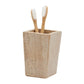 A rectangular stone toothbrush holder from the Bowen Natural Bath Collection by Pigeon & Poodle, featuring two bamboo toothbrushes with white bristles.