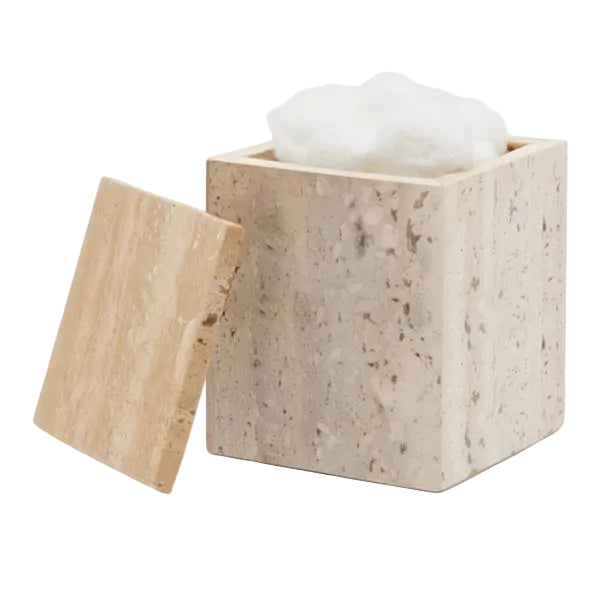A square beige stone container from the Bowen Natural Bath Collection by Pigeon & Poodle, with a matching lid beside it, holds white cotton balls inside.