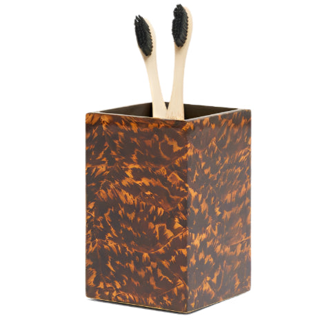 Pigeon & Poodle's Carmel High Gloss Faux Tortoise holder boasts a unique rectangular brown tortoise shell style and comes with two bamboo toothbrushes with black bristles.