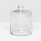 The Darby Clear Canister Collection by Pigeon & Poodle features a clear glass jar with a round lid and knob, making it an elegant, versatile storage solution—ideal as a chic bathroom organizer.