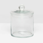 The Darby Clear Canister Collection by Pigeon & Poodle features a clear glass jar with a round lid and knob, making it an elegant, versatile storage solution—ideal as a chic bathroom organizer.