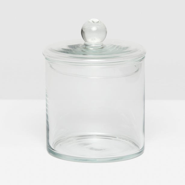 The Darby Clear Canister Collection by Pigeon & Poodle features a clear glass jar with a round lid and knob, making it an elegant, versatile storage solution—ideal as a chic bathroom organizer.
