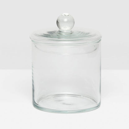 The Darby Clear Canister Collection by Pigeon & Poodle features a clear glass jar with a round lid and knob, making it an elegant, versatile storage solution—ideal as a chic bathroom organizer.