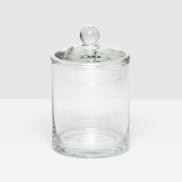 The Darby Clear Canister Collection by Pigeon & Poodle features an empty glass container with a round lid and knob, shown on a white surface—perfect as versatile storage or a chic bathroom organizer.