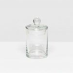 The Darby Clear Canister Collection by Pigeon & Poodle features a clear glass container with a round lid and knob, ideal as a bathroom organizer or for versatile storage throughout your home.