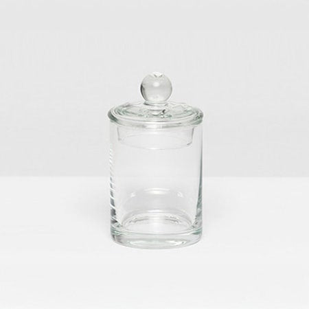 The Darby Clear Canister Collection by Pigeon & Poodle features a clear glass container with a round lid and knob, ideal as a bathroom organizer or for versatile storage throughout your home.