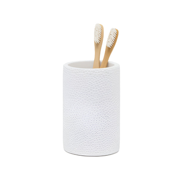 The Pigeon & Poodle Dover Bath Collection features a white textured resin toothbrush holder, shown with two bamboo toothbrushes against a plain white background—an ideal modern bathroom accessory.