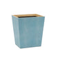 The Manchester Bath Collection wastebasket by Pigeon & Poodle features a square, light blue, textured shagreen exterior and a light wood veneer trim interior, shown against a white background.