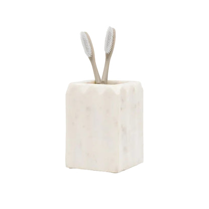 A pleated marble-patterned toothbrush holder from the Proviso White Bath Collection by Pigeon & Poodle holds two beige toothbrushes, displayed on a white background—an elegant touch for luxury home decor.