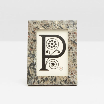 From Pigeon & Poodle’s Corsica Frame Collection, this rectangular frame features a marbled stone pattern and displays a print of a decorative black “P” with floral accents on a white background.
