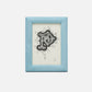From the Oxford Frame Collection by Pigeon & Poodle, this framed artwork showcases an ornate black and white letter "P" with decorative swirls, set in a textured light blue frame for added style and durability.