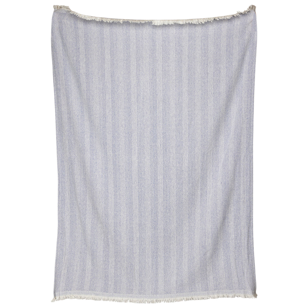 The Lavanya Throw Collection by John Robshaw showcases a light blue and white striped cotton textile with a subtle herringbone weave, fringed top and bottom, displayed against a white background.