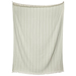 The Lavanya Throw Collection by John Robshaw features a light beige rectangular cotton throw with subtle vertical stripes and fringed edges, displayed against a white background.