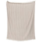 The Lavanya Throw Collection by John Robshaw features a beige, yarn-dyed woven cotton blanket with subtle vertical stripes and fringe, displayed against a plain background.