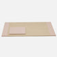 From the Asby Desk Accessory Collection by Pigeon & Poodle, this rectangular full-grain leather mat features neutral tones with pinkish-beige padded ends—one end has a small raised cushion—an elegant addition to your workspace.