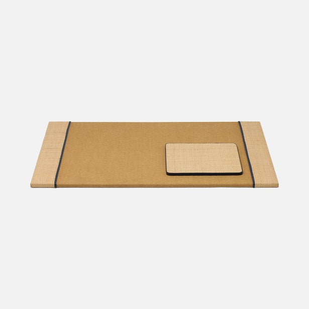 The Hanford Desk Accessory Collection by Pigeon & Poodle features a rectangular woven raffia mat and a matching cushion in tan and beige with dark trim, displayed on a white background.