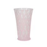 The Juliska Trellis Drinkware Collection features tall, translucent pink glassware with a diamond-patterned texture and slightly flared rims—an elegant addition to any setting.