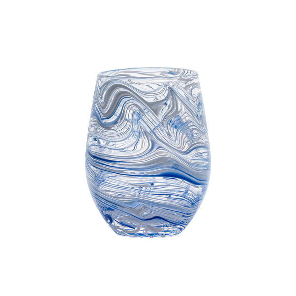 The Juliska Puro Marbled Drinkware Collection features a clear glass tumbler with swirling blue and grey patterns evoking seaglass hues, set against a plain white background.