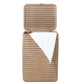 The Mocha Whitewashed Lorain Hamper by Pigeon & Poodle features horizontal rattan weaving, an open lid, and a white towel draped over the edge, all set against a plain white background.